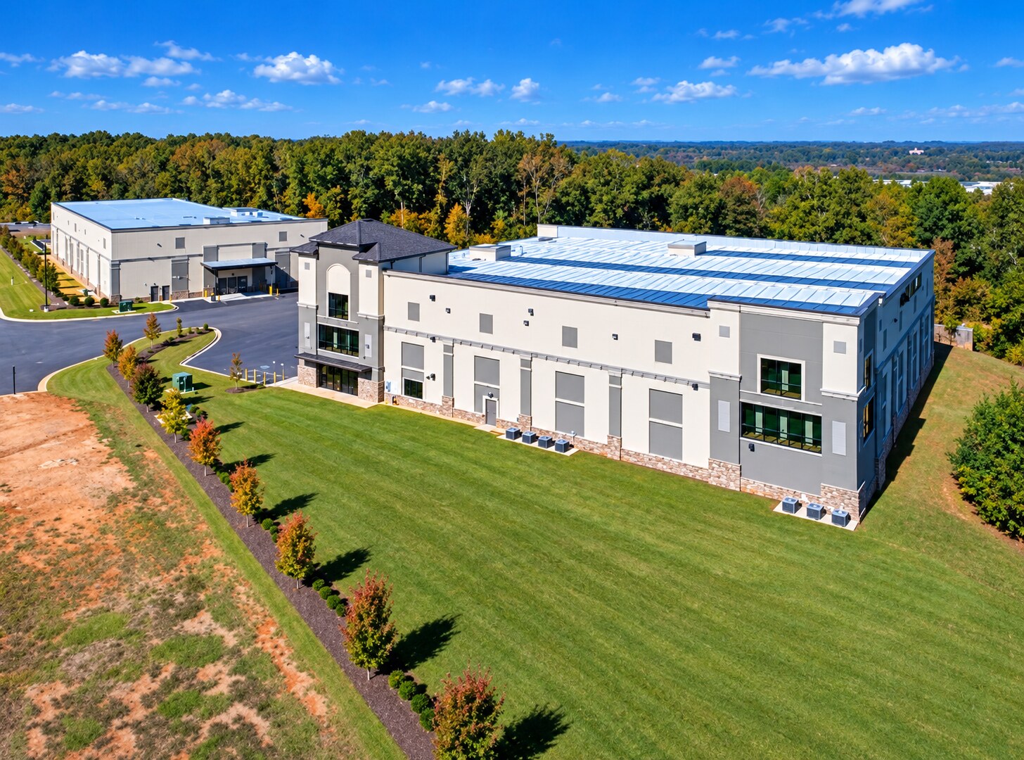 Aerial view of a completed multi-building self-storage facility surrounded by trees